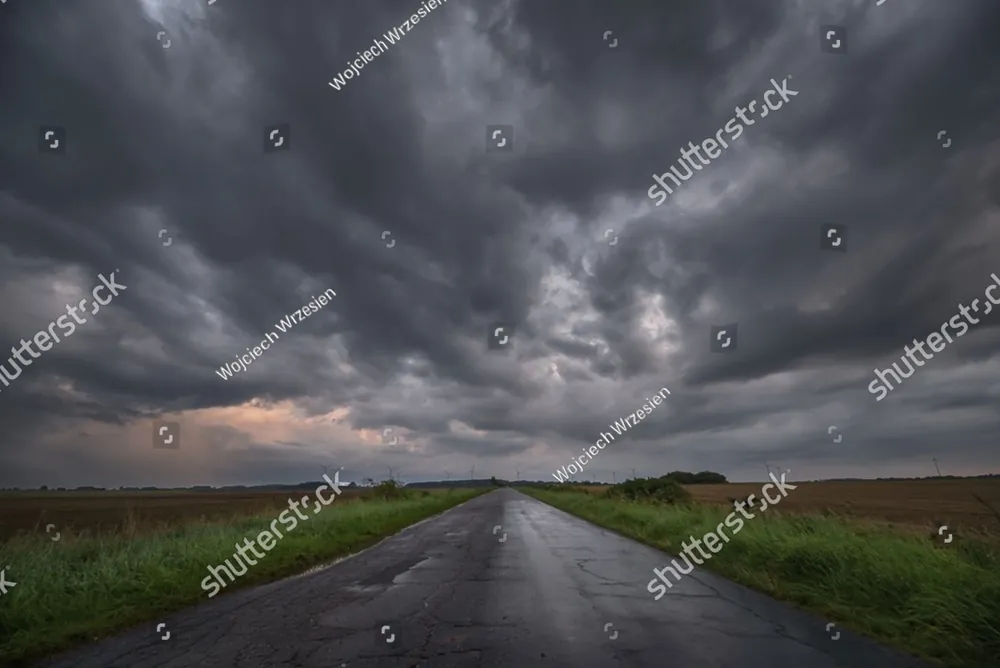 Dark storm clouds over an empty country road