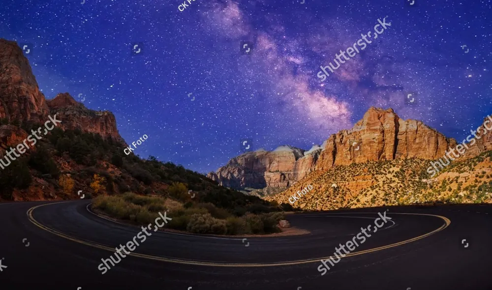 The Milky Way above a winding road through red rock